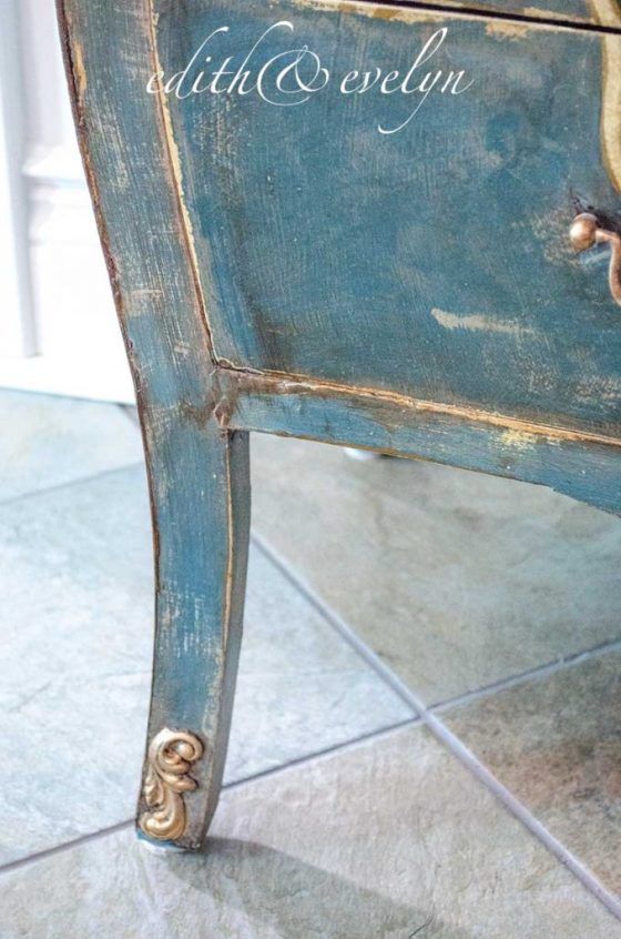 an old blue chair with writing on it