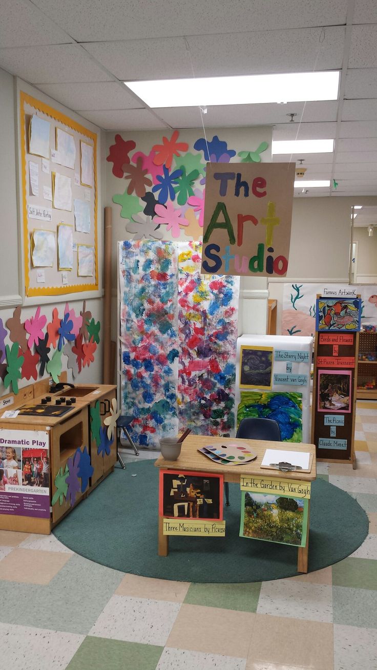 the classroom is decorated with colorful paper flowers and bookshelves for children to read