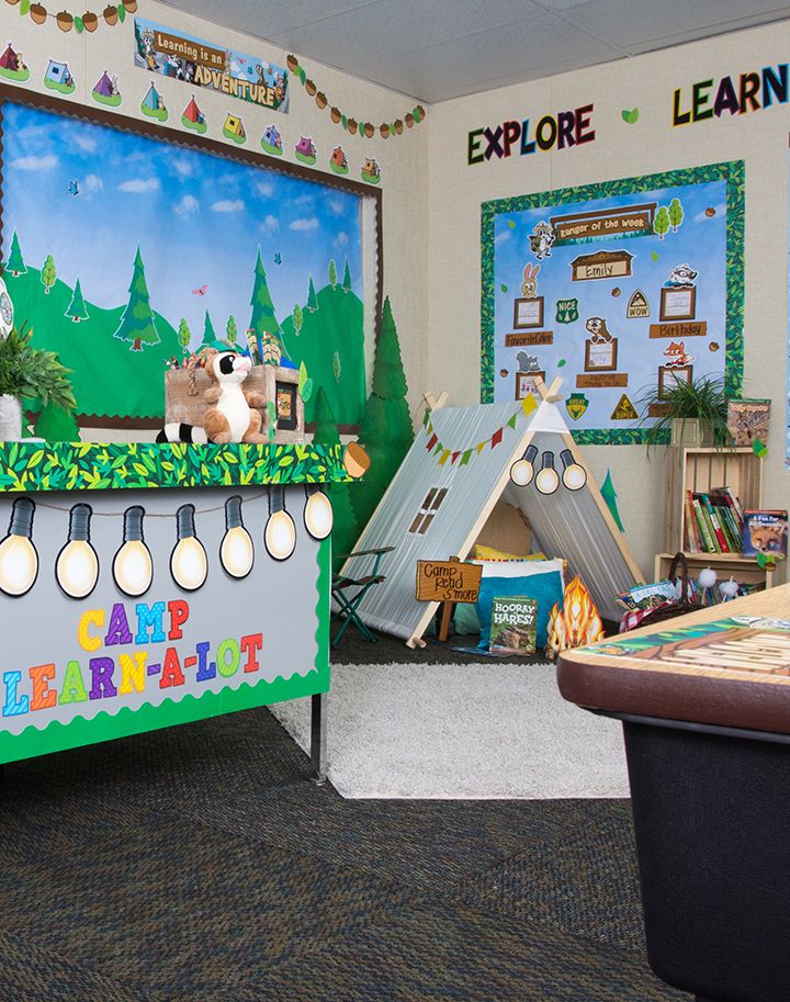 the classroom is decorated in green and white with pictures on the wall, including an animal theme