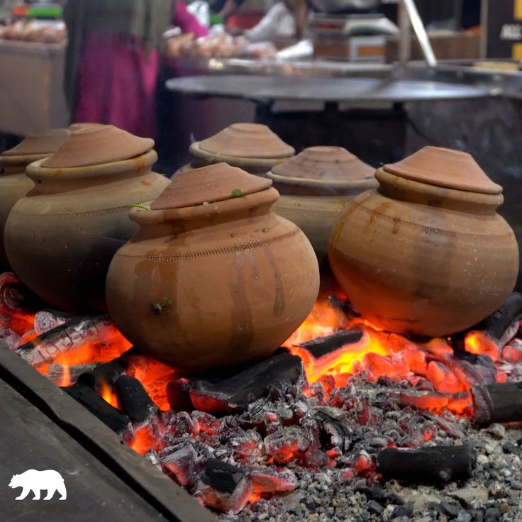 pots sitting on top of an open fire pit