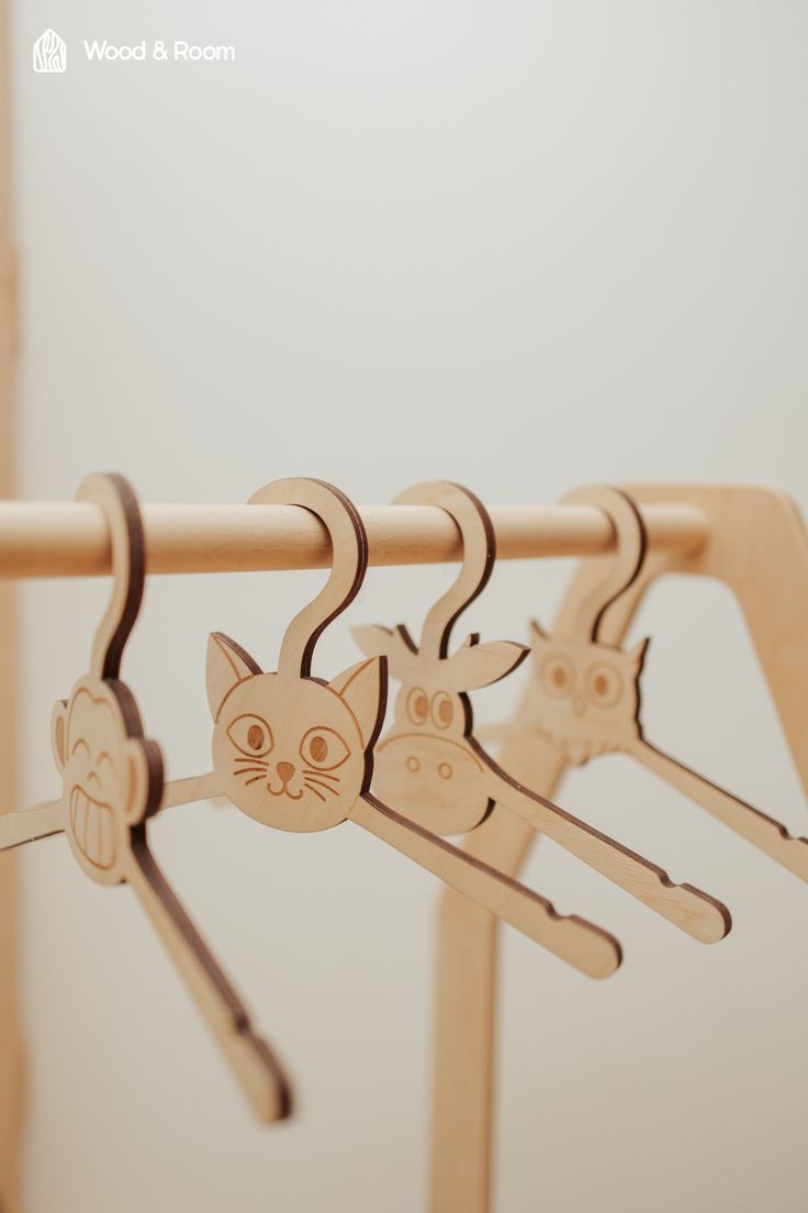 wooden clothes hangers with cats on them