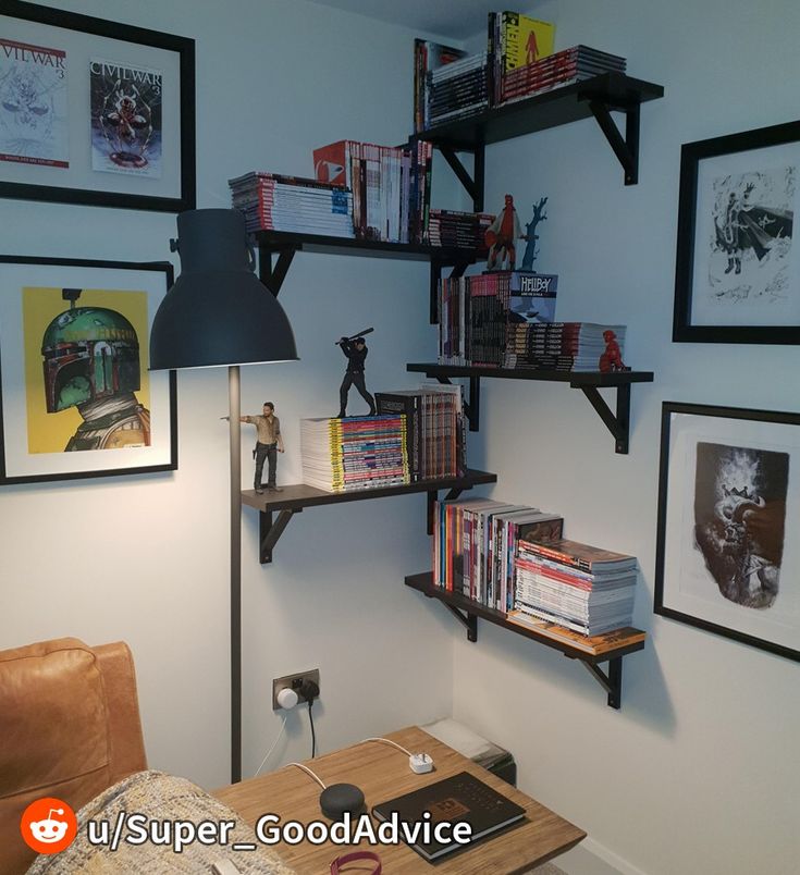 a living room with bookshelves and pictures on the wall