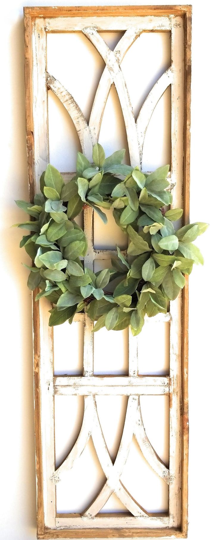 a wooden frame with a wreath hanging on it