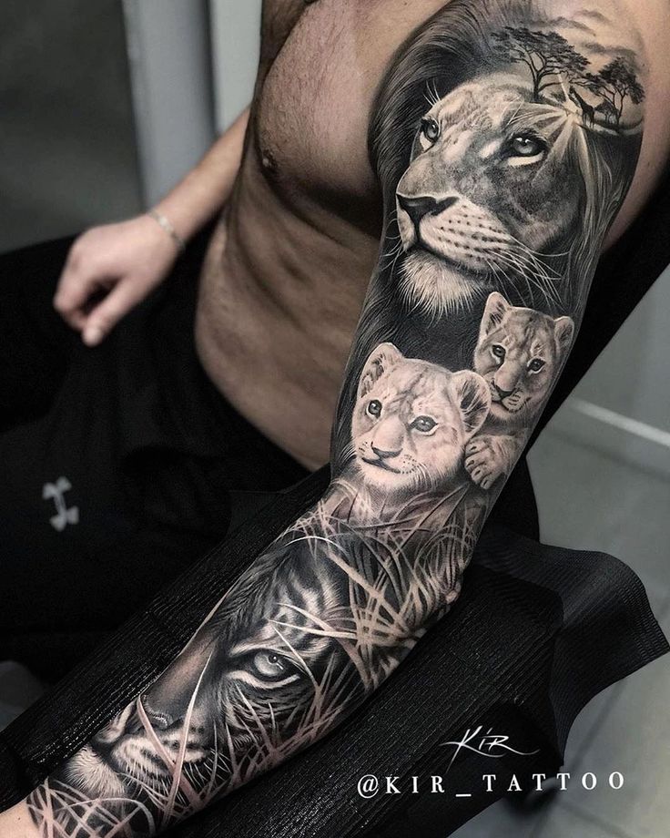 a man's arm with tattoos on it and two lions in the middle of his arm