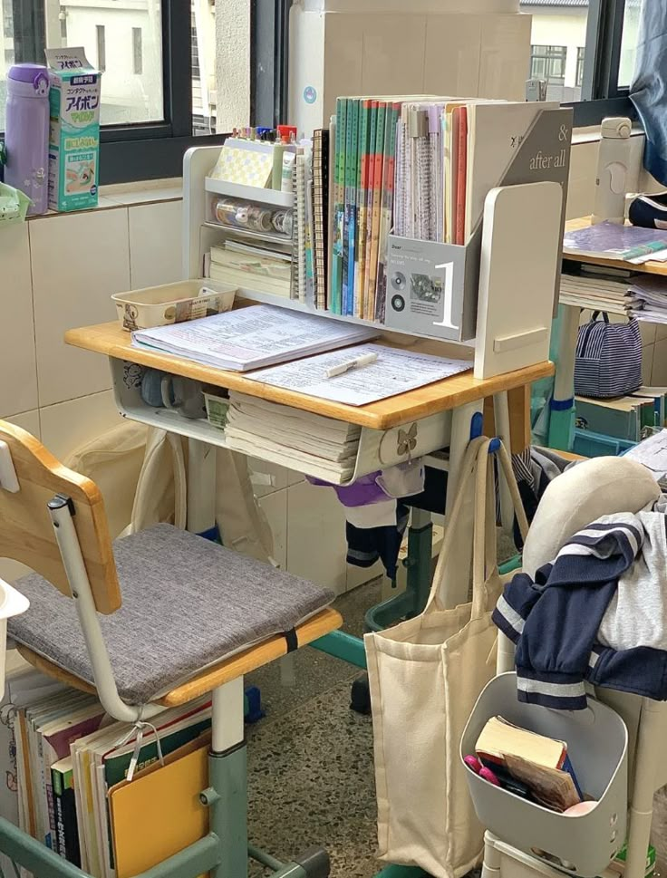 a room filled with lots of clutter and books on top of wooden desks