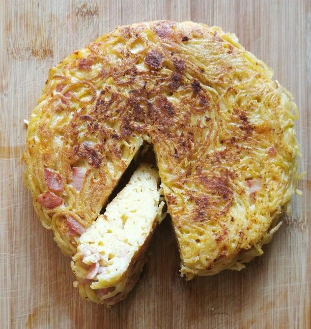 an omelet is cut in half on a cutting board