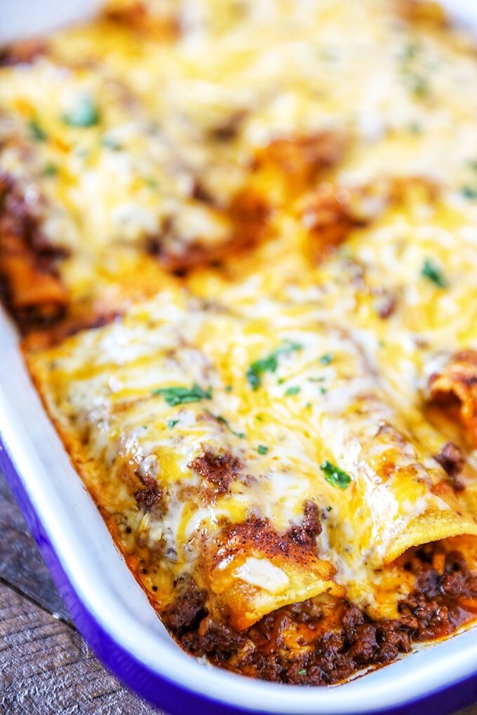 a casserole dish with meat and cheese in it sitting on a table top