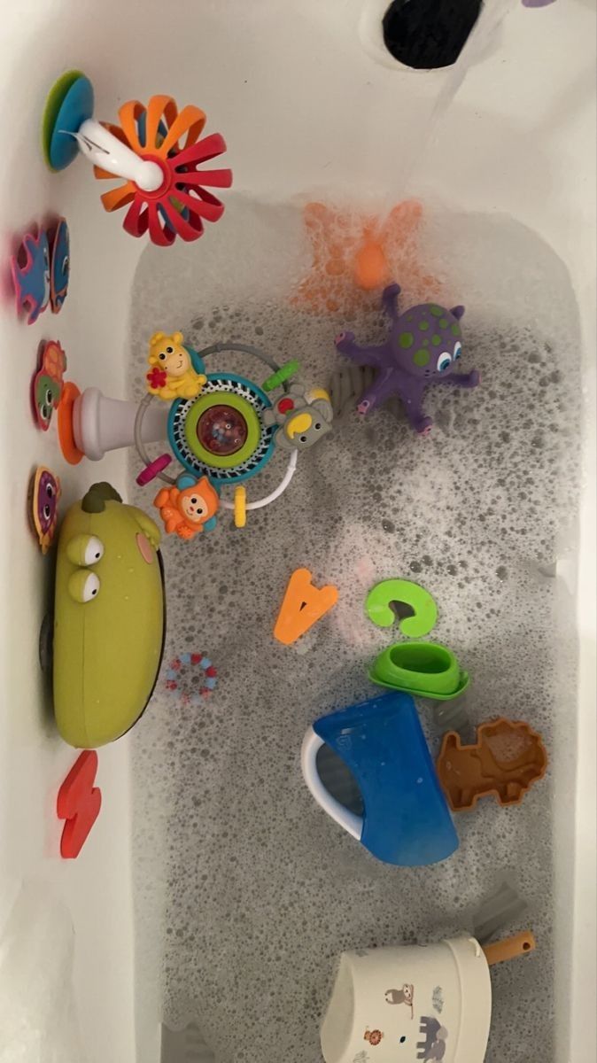 a bath tub filled with toys and water