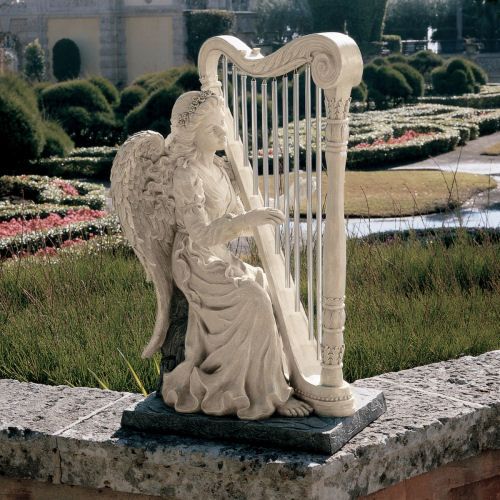 a statue of an angel playing a harp