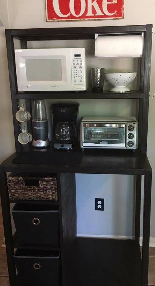 there is a microwave, toaster and other kitchen items on the shelf