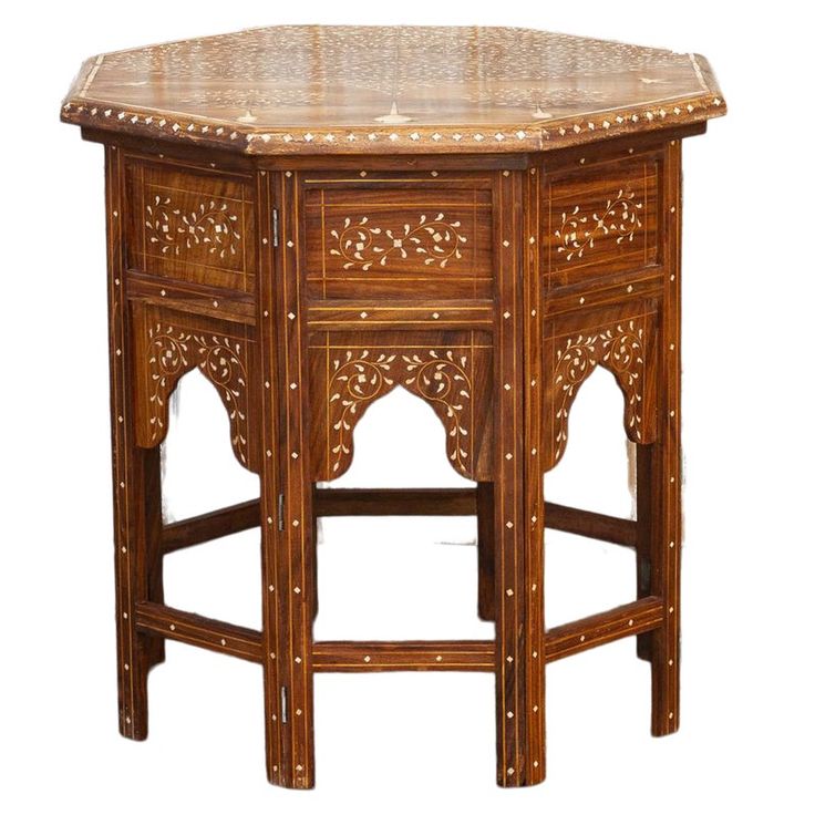 a wooden table with an intricate design on it's top and bottom, against a white background