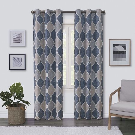 a living room filled with furniture and a large window covered in blue patterned curtains next to a white rug