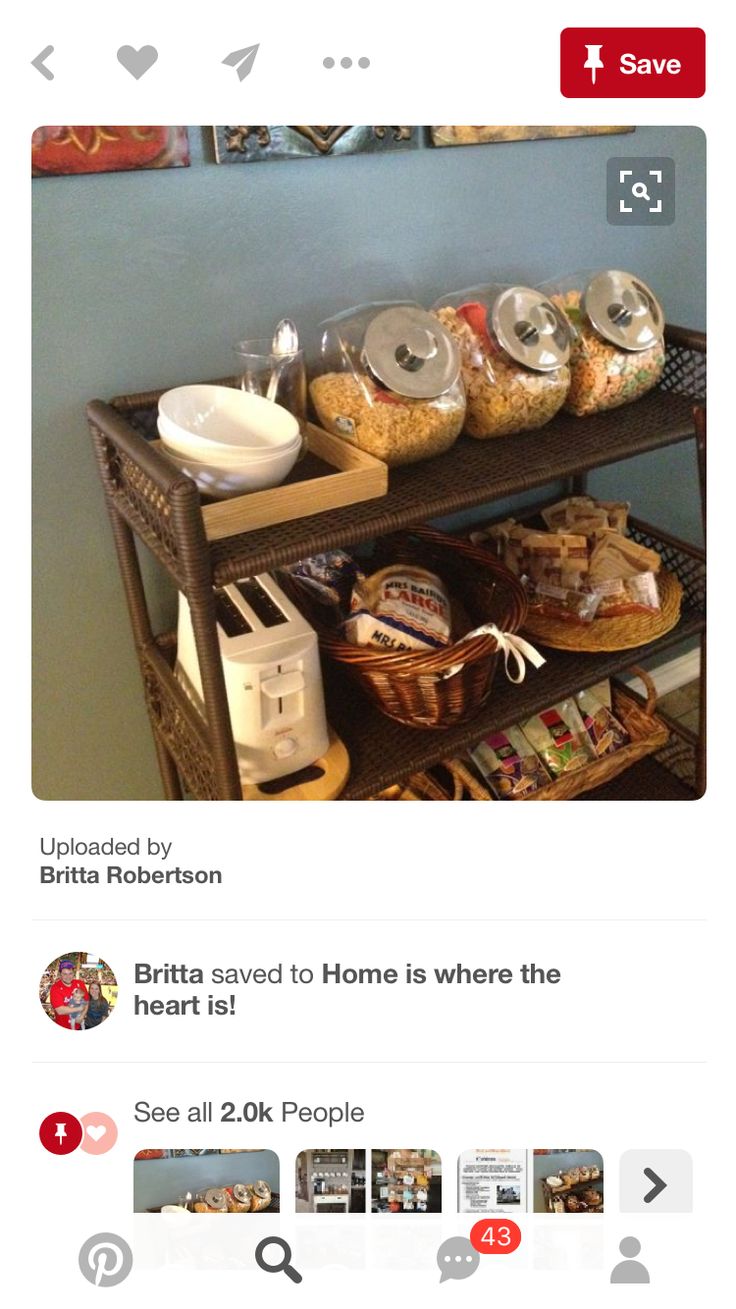 a shelf filled with lots of food next to a painting on the wall in a room