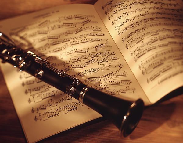 a flute resting on top of an open book