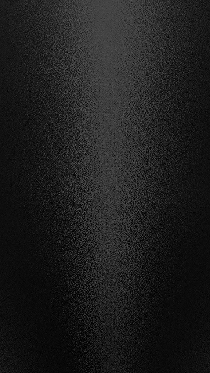 a black leather textured surface with some light reflections on the top and bottom part