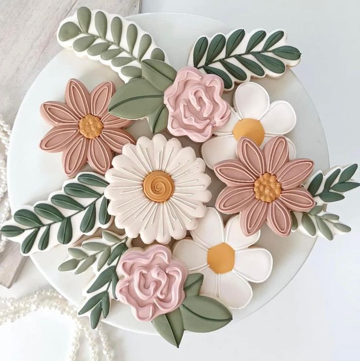 a white plate topped with flowers on top of a table