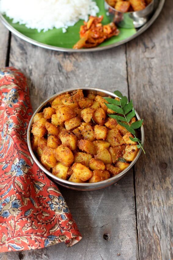 two bowls filled with food on top of a wooden table