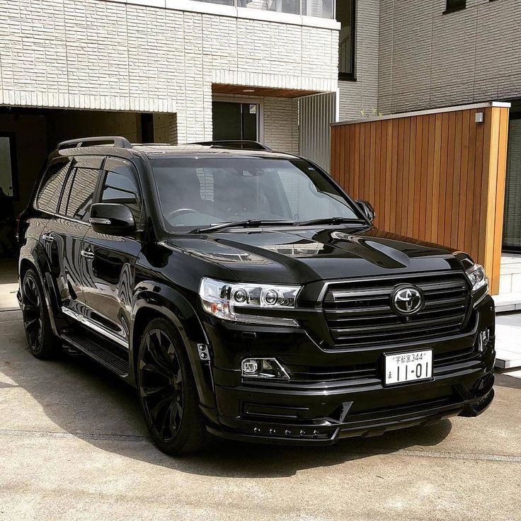 a black suv parked in front of a building