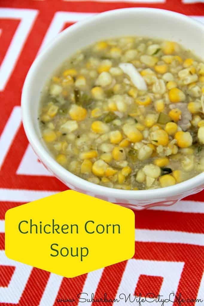 chicken corn soup in a white bowl on a red and white tablecloth