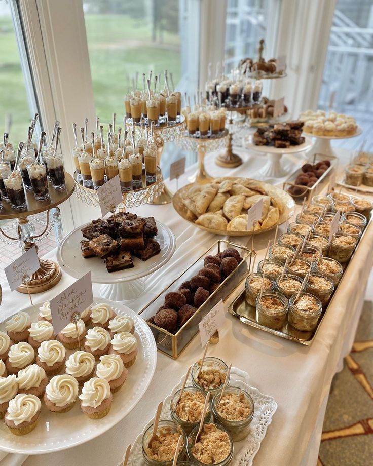 a table filled with lots of desserts and pastries