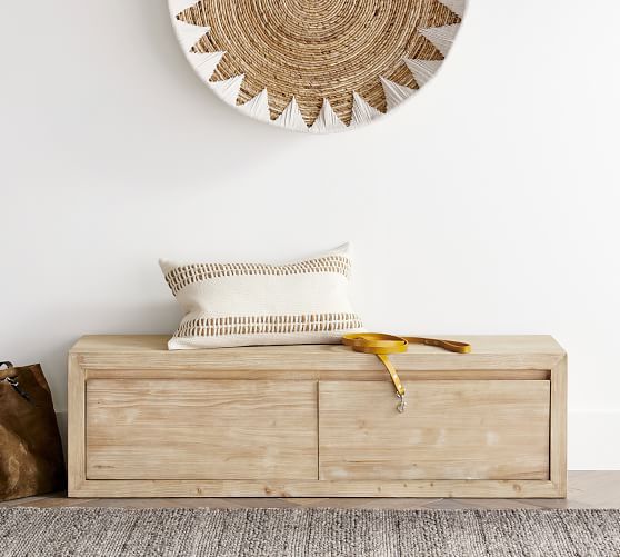 a wooden bench with a banana sitting on it in front of a wall mounted clock