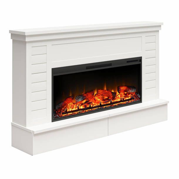 an electric fireplace with flames and logs on the sides, in white painted wood paneling