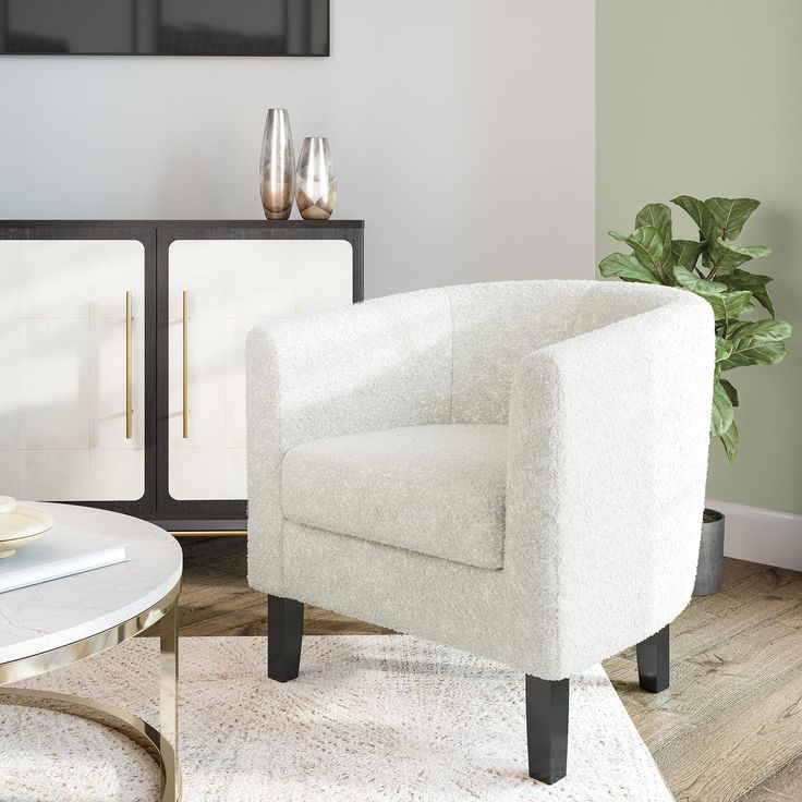 a white chair sitting in front of a glass table