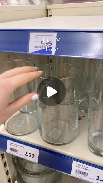 a person is pointing at some glasses on the shelf