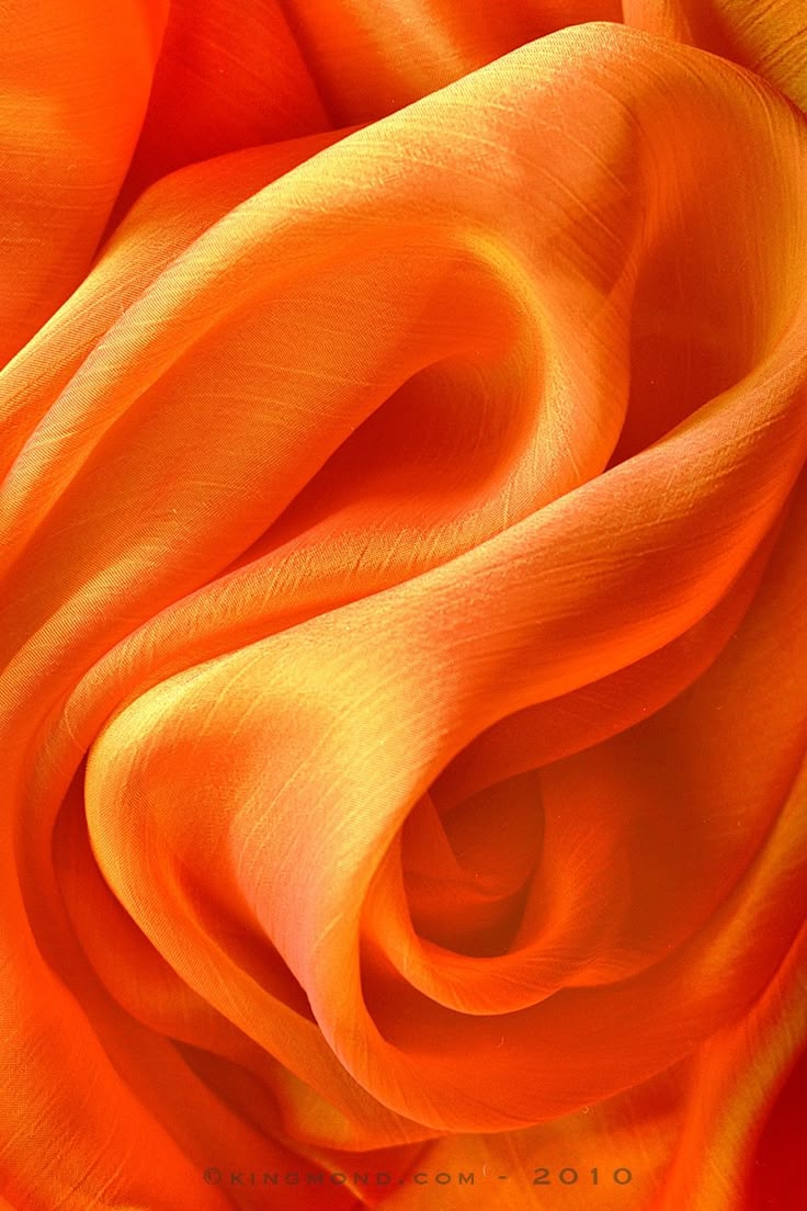 an orange silk fabric is shown in close up