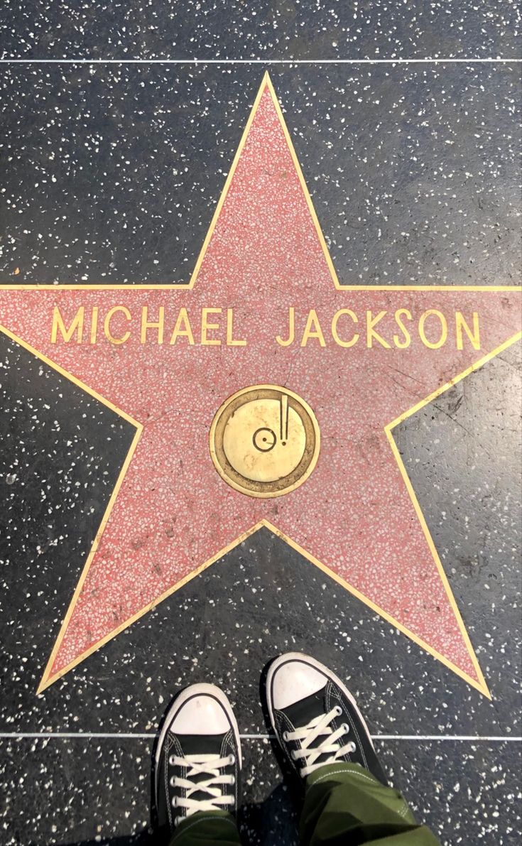 a person standing in front of a star on the hollywood walk of fame