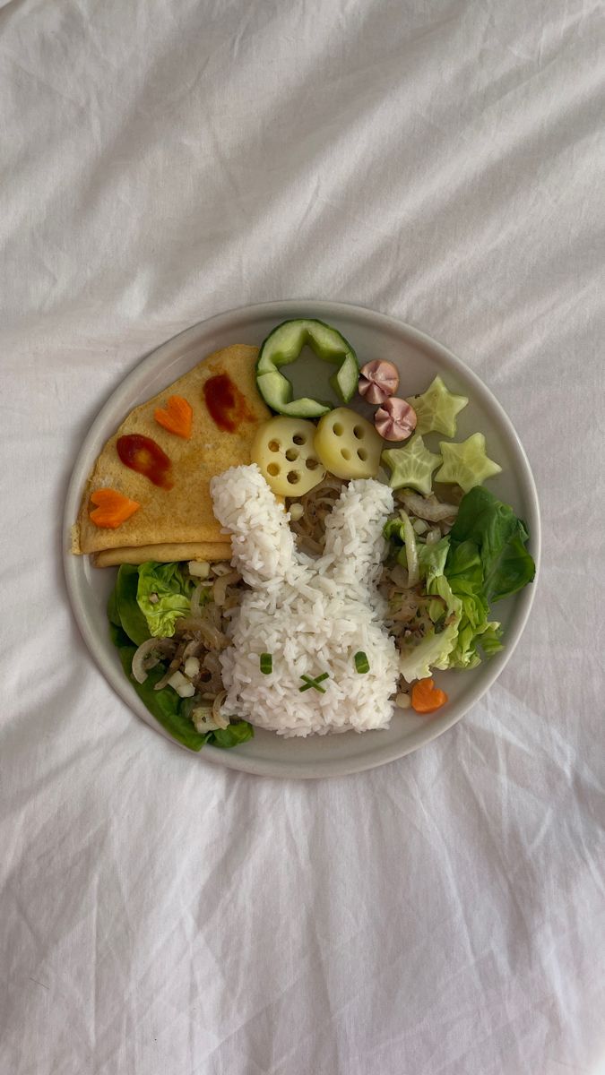 a white plate topped with rice and veggies