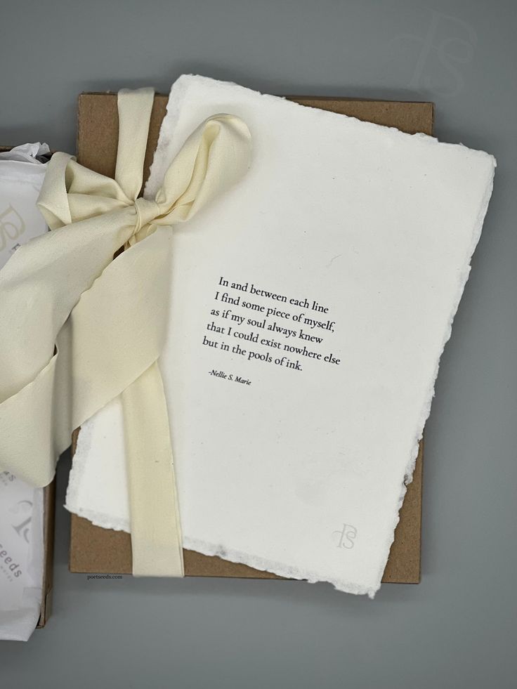 a piece of paper with a poem written on it next to some folded napkins