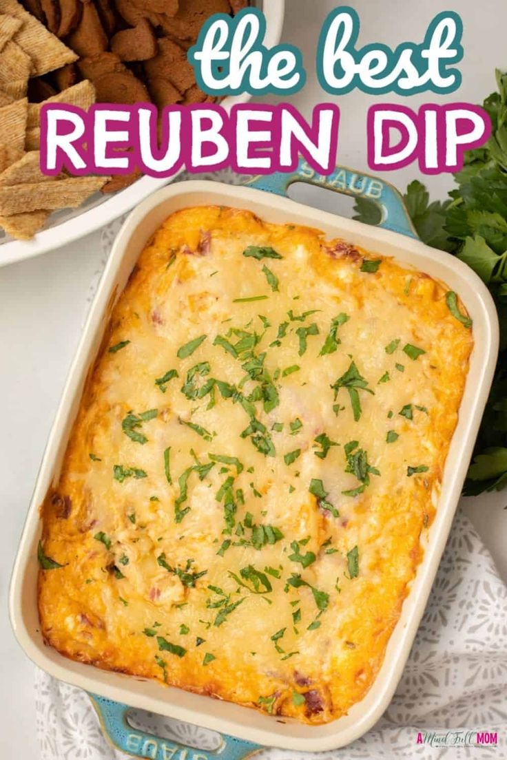 the best reuben dip recipe in a casserole dish next to crackers and parsley