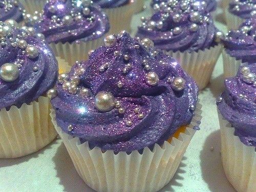 cupcakes with purple frosting and silver decorations