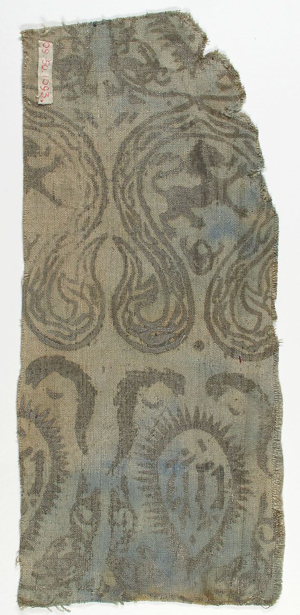 an old piece of cloth with designs on it