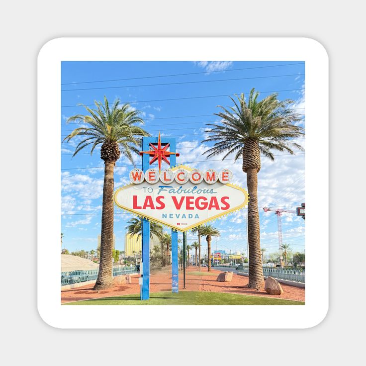 the welcome sign to las vegas is shown in front of palm trees and blue sky