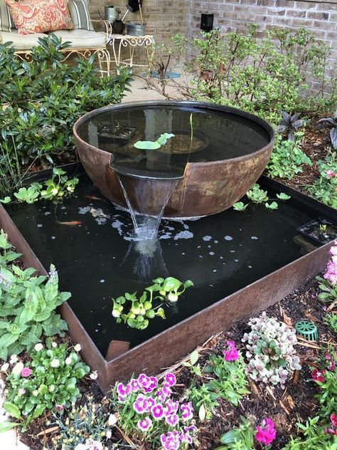 a water fountain in the middle of a garden