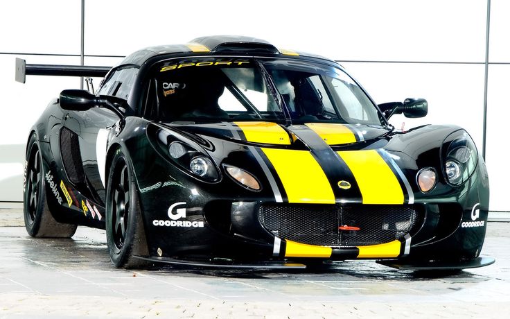 a black and yellow sports car parked in a garage