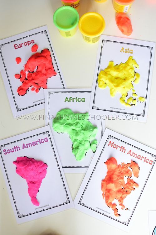 four children's handprinted maps of africa and south america are shown on the table