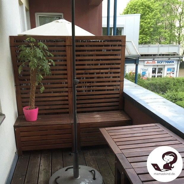 a wooden bench sitting on top of a wooden floor next to a potted plant