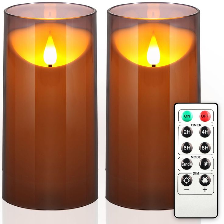 two lit candles with remote controls next to each other