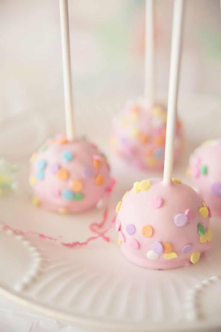 cake pops with sprinkles are on a plate