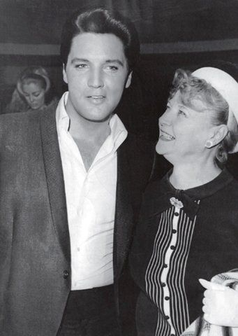 an old photo of a man and woman standing next to each other