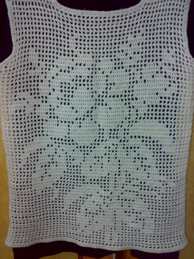 a white crocheted tank top on a mannequin torso with holes in the middle