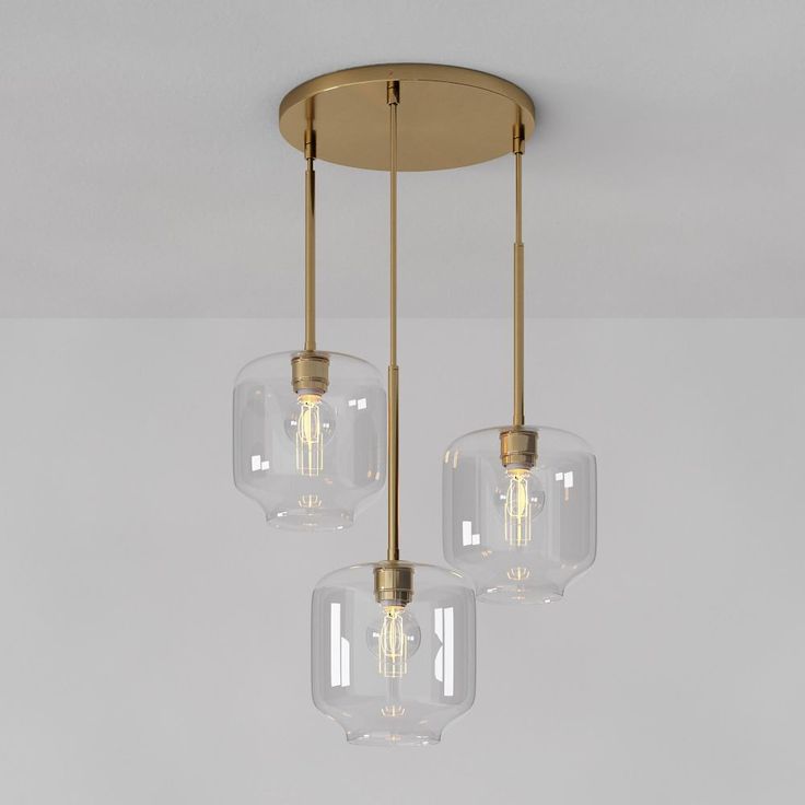 three clear glass lights hanging from a ceiling fixture