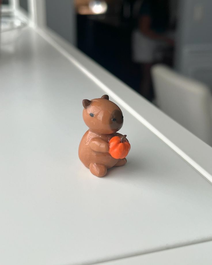 a small toy bear sitting on top of a counter