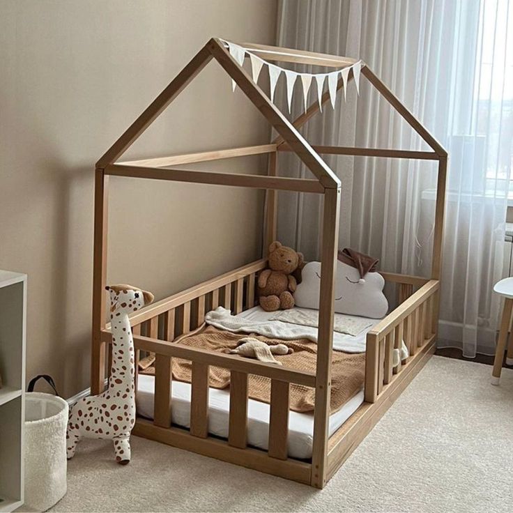 a child's bed with a wooden frame and canopy