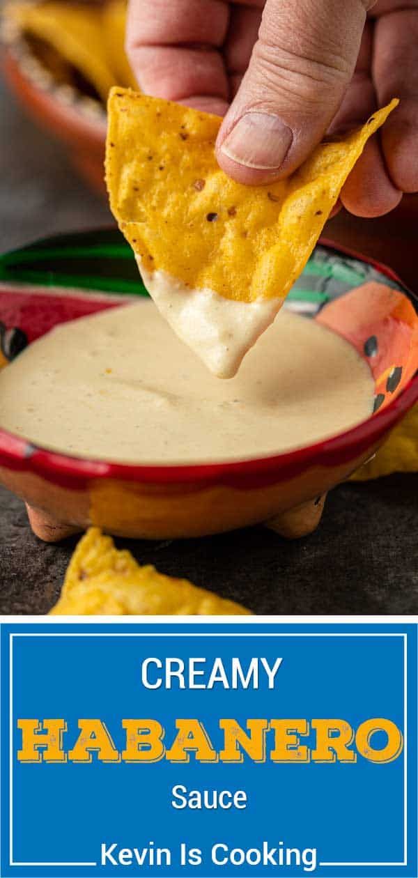 a hand holding a tortilla chip over a bowl of cream sauce with the text creamy habanero sauce on it