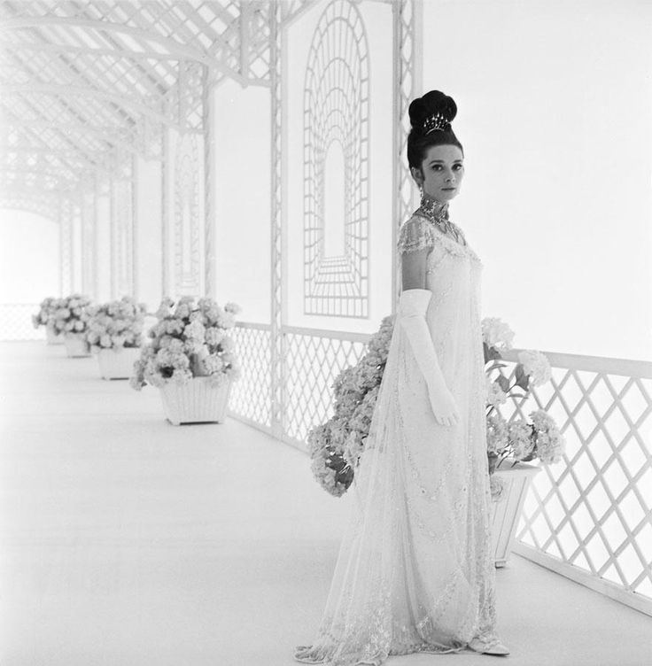 a black and white photo of a woman in a wedding dress wearing a tiara