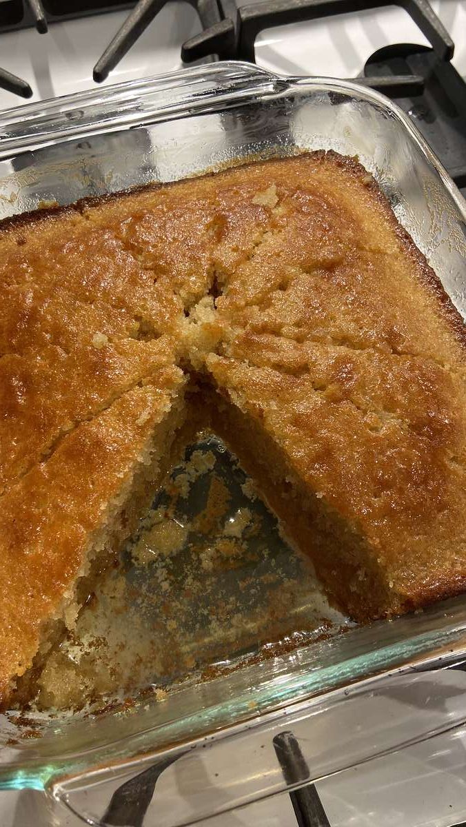 a cake that has been cut in half on a stove top with one slice taken out